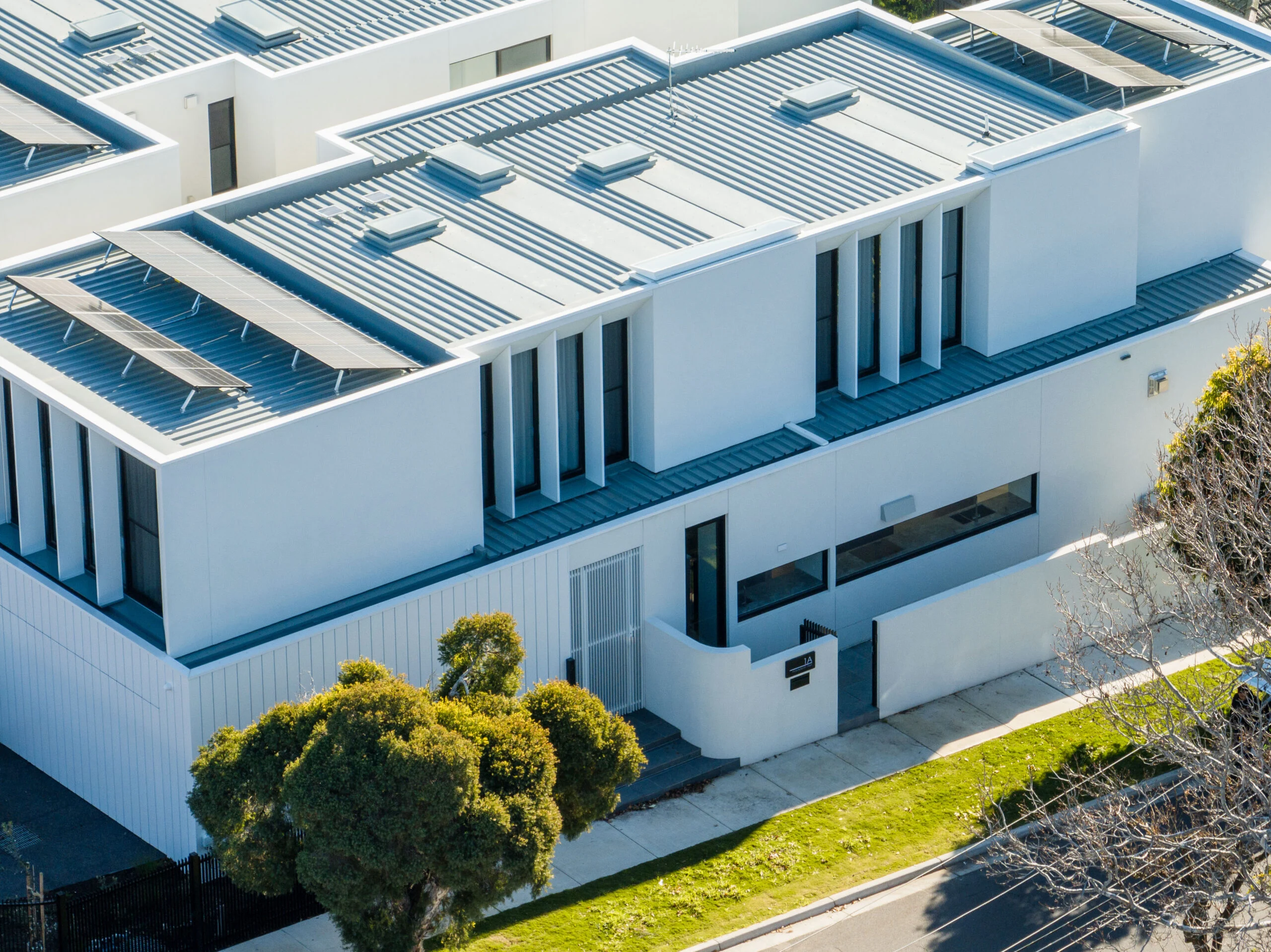 Close aerial detail of a modern home's roofline and facade
